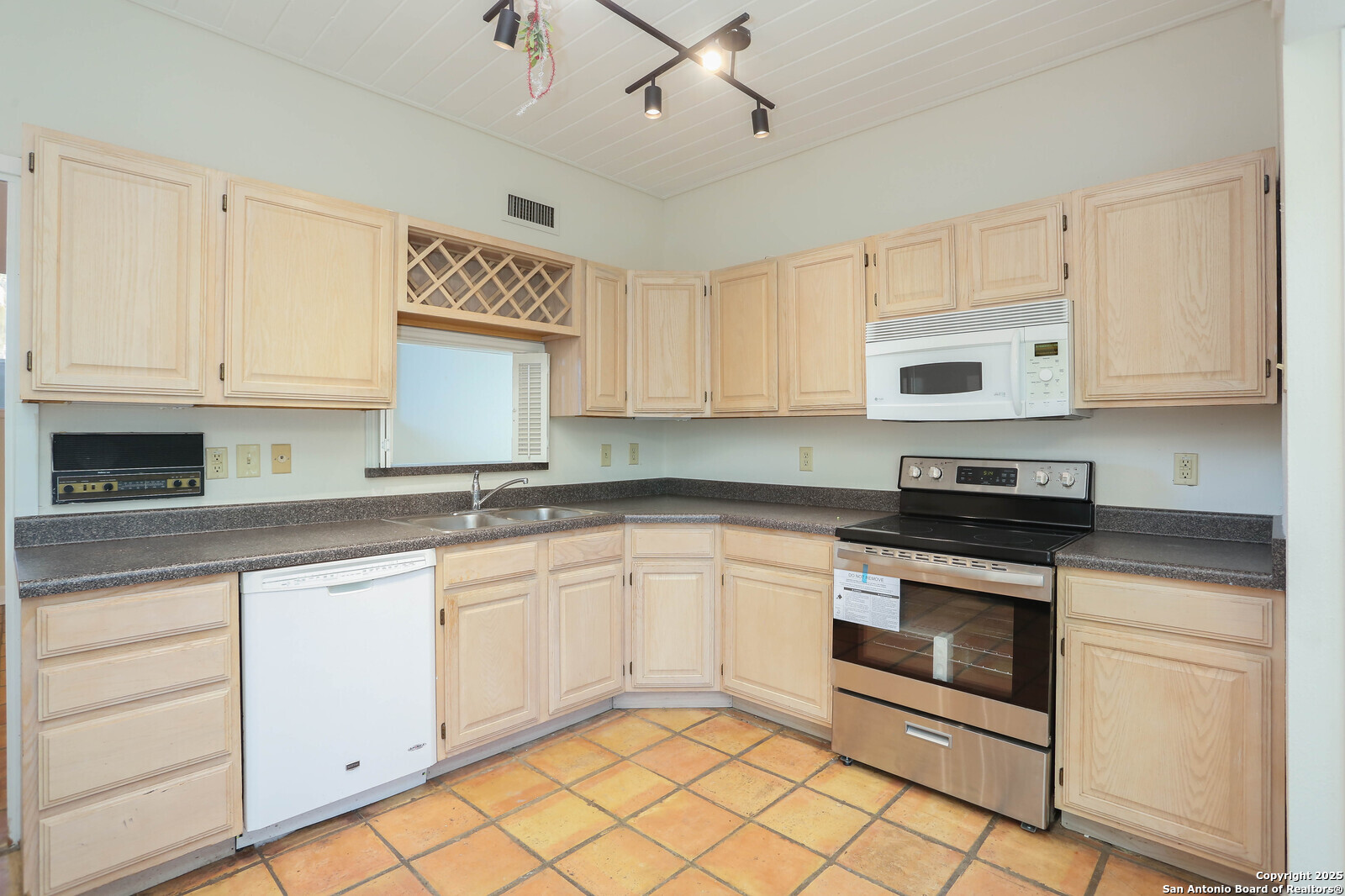 3102 Eisenhauer Road, Unit B16 San Antonio, TX 78209 - Photo 9 of 31 a kitchen with cabinets appliances and a sink