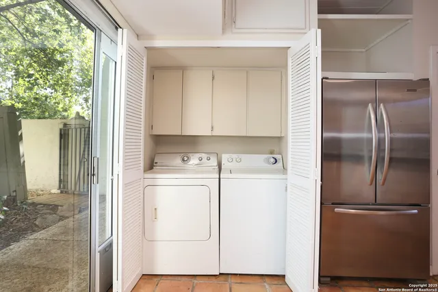a view of storage and utility room with washer and dryer
