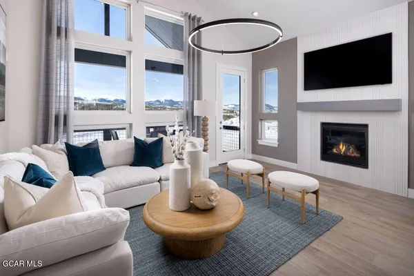 a living room with furniture a flat screen tv and a fireplace