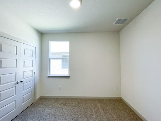 10616 Defender Trail Austin, TX 78754 - Photo 12 of 25 Unfurnished bedroom with a closet and carpet floors