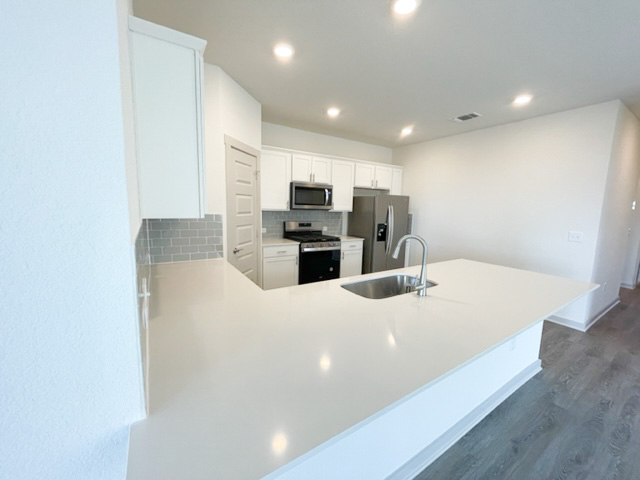 10616 Defender Trail Austin, TX 78754 - Photo 14 of 25 a large kitchen with a large counter top appliances and cabinets