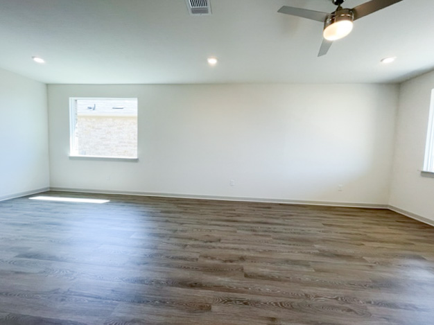 10616 Defender Trail Austin, TX 78754 - Photo 18 of 25 an empty room with wooden floor and windows