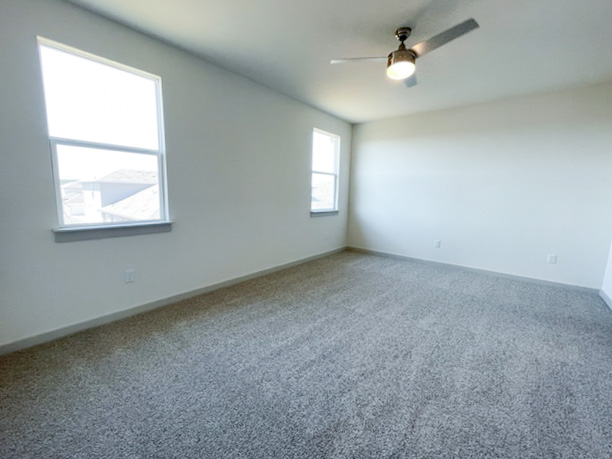 10616 Defender Trail Austin, TX 78754 - Photo 21 of 25 an empty room with a window and a fan