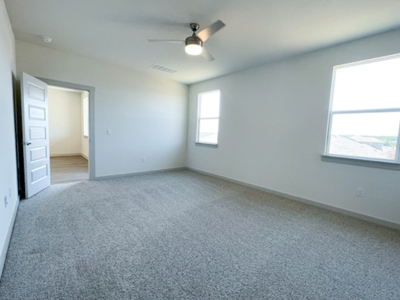10616 Defender Trail Austin, TX 78754 - Photo 23 of 25 an empty room with a window and a ceiling fan