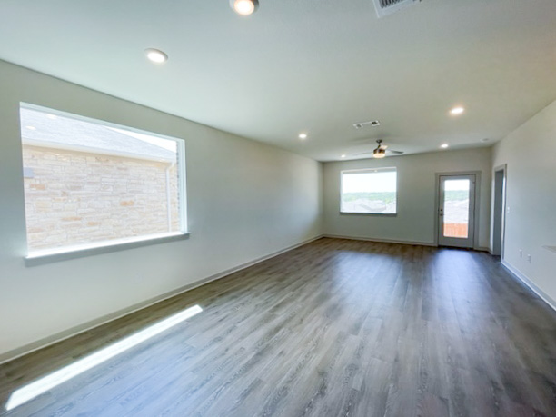 10616 Defender Trail Austin, TX 78754 - Photo 4 of 25 an empty room with wooden floor and windows