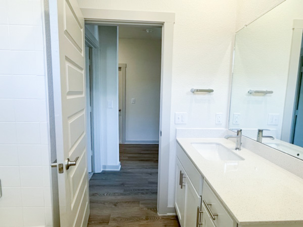 10616 Defender Trail Austin, TX 78754 - Photo 7 of 25 a bathroom with a sink a mirror and a shower
