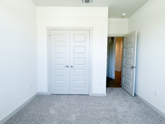 10616 Defender Trail Austin, TX 78754 - Photo 10 of 25 Unfurnished bedroom featuring a closet and light colored carpet