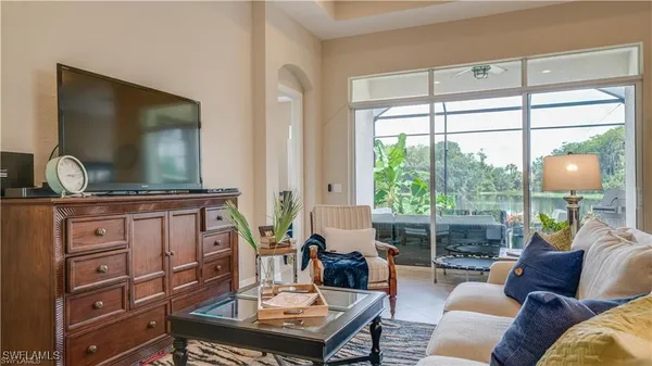 a dining room with furniture a window and a chandelier