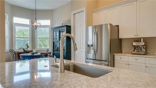 a kitchen with stainless steel appliances granite countertop a stove and cabinets