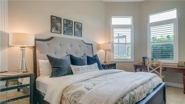 a bedroom with two bed and a flat screen tv