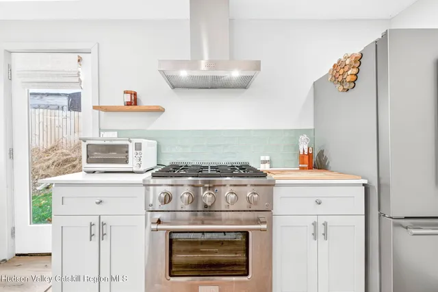 a stove top oven sitting inside of a kitchen