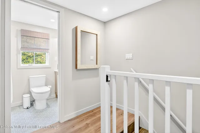a bathroom with a toilet a sink and a window