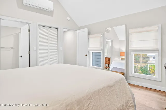 a spacious bedroom with a large bed and a window