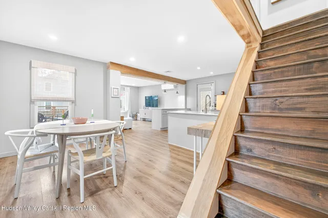 a view of a dining room with furniture wooden floor and a chandelier