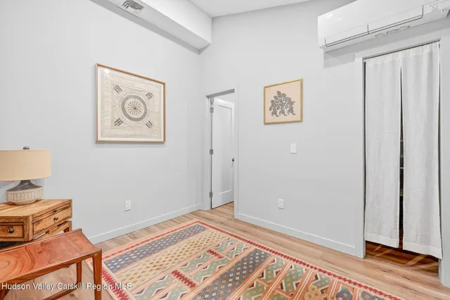 a view of a room with wooden floor and closet