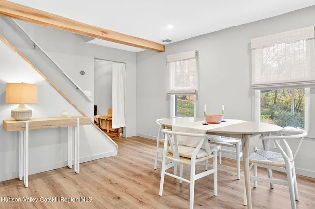 a view of a dining room with furniture and a window