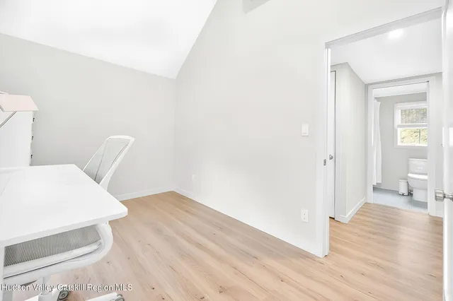 a view of a room with wooden floor and furniture