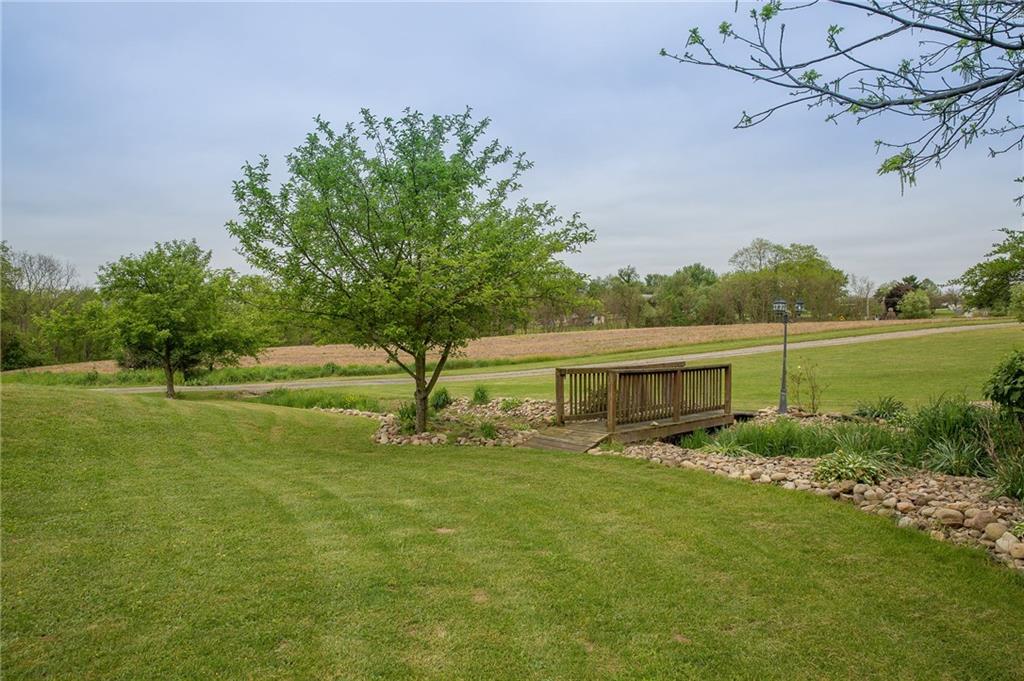 131 West Brewster Road Butler, PA 16001 - Photo 3 of 25 Quaint wooded bridge adds to the charm and serenity of this amazingly landscaped back yard