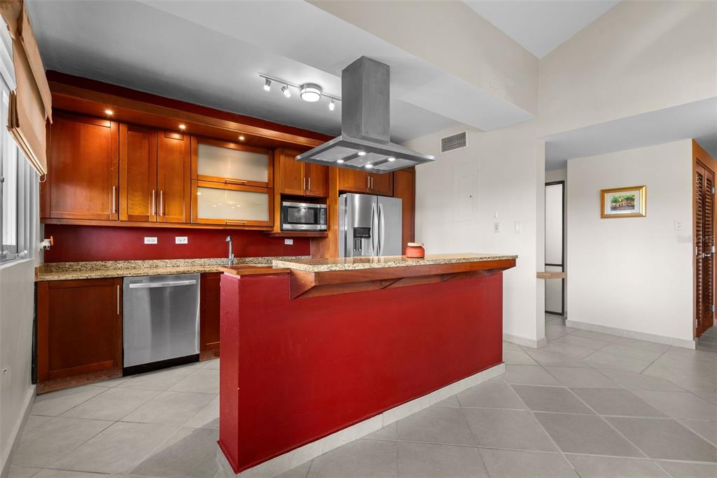 * Academy Drive Drive, Unit 25 Humacao, PR 00791 - Photo 11 of 37 a kitchen with stainless steel appliances granite countertop a stove a sink and a refrigerator