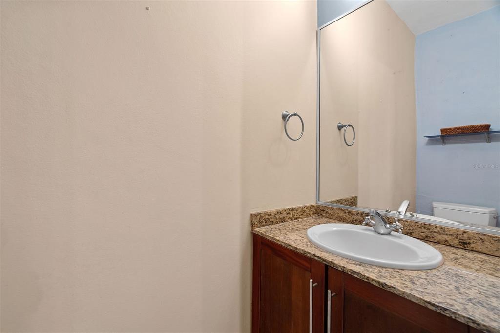 * Academy Drive Drive, Unit 25 Humacao, PR 00791 - Photo 18 of 37 a bathroom with a granite countertop sink and a mirror