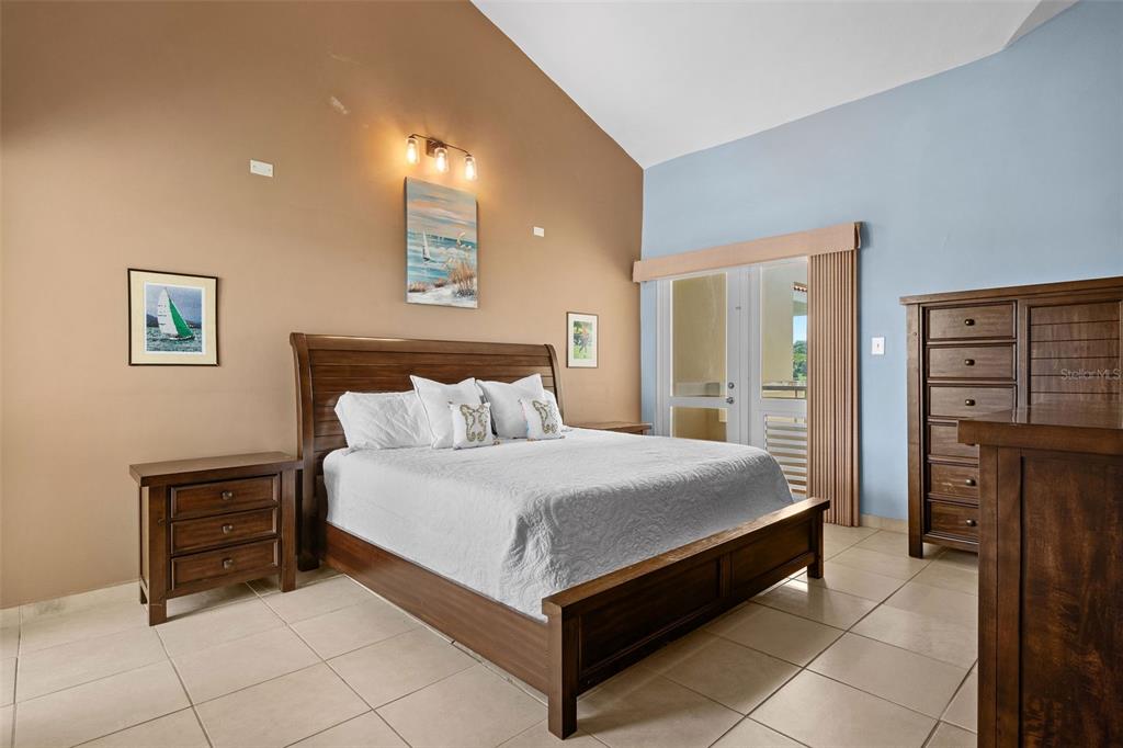 * Academy Drive Drive, Unit 25 Humacao, PR 00791 - Photo 23 of 37 a large bed sitting in a bedroom and night stand