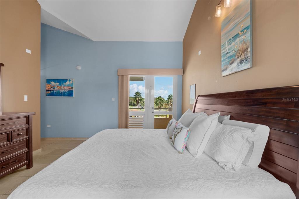 * Academy Drive Drive, Unit 25 Humacao, PR 00791 - Photo 25 of 37 a bedroom with a bed and a painting on the wall