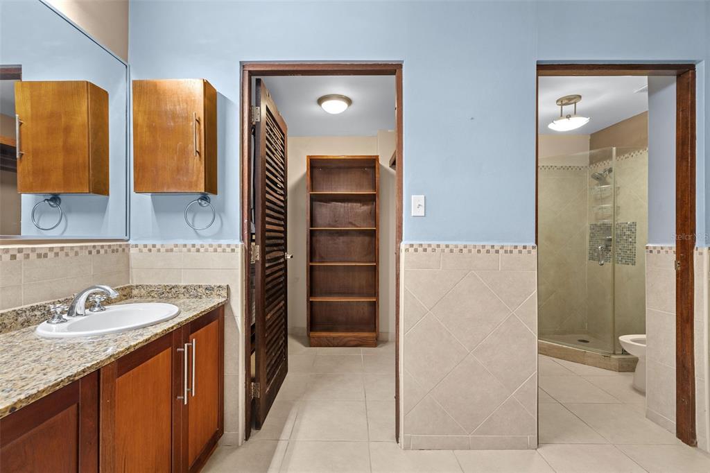 * Academy Drive Drive, Unit 25 Humacao, PR 00791 - Photo 28 of 37 a en suite bathroom with a granite countertop sink and a mirror