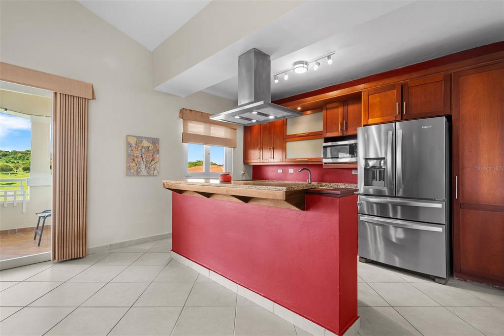 * Academy Drive Drive, Unit 25 Humacao, PR 00791 - Photo 10 of 37 a kitchen with stainless steel appliances granite countertop a refrigerator and a stove