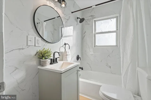 a bathroom with a sink a toilet and a mirror