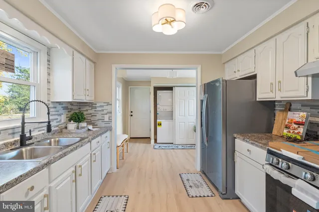 a kitchen with a sink stove and refrigerator