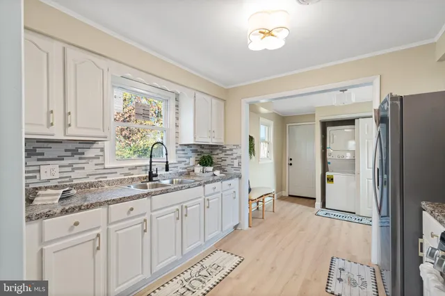 a kitchen with a sink stove and cabinets