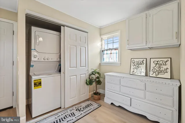 a utility room with cabinets washer and dryer