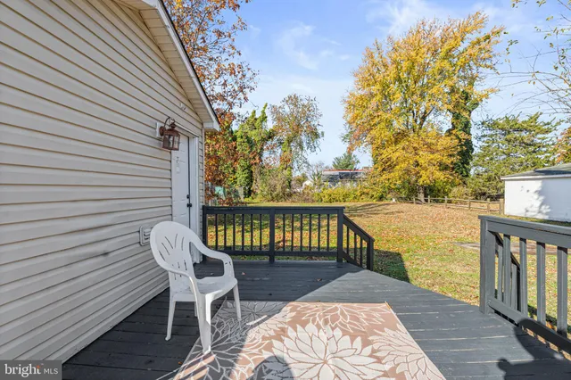 a view of balcony with wooden floor and seating space
