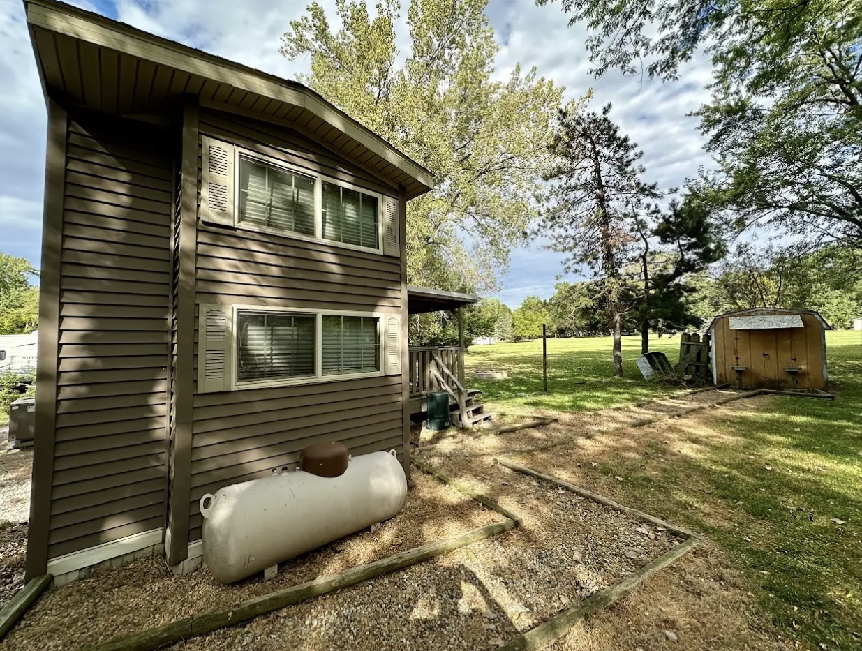 18-62-63 Woodhaven Sublette, IL 61367 - Photo 6 of 20 a view of a house with a yard and a large tree