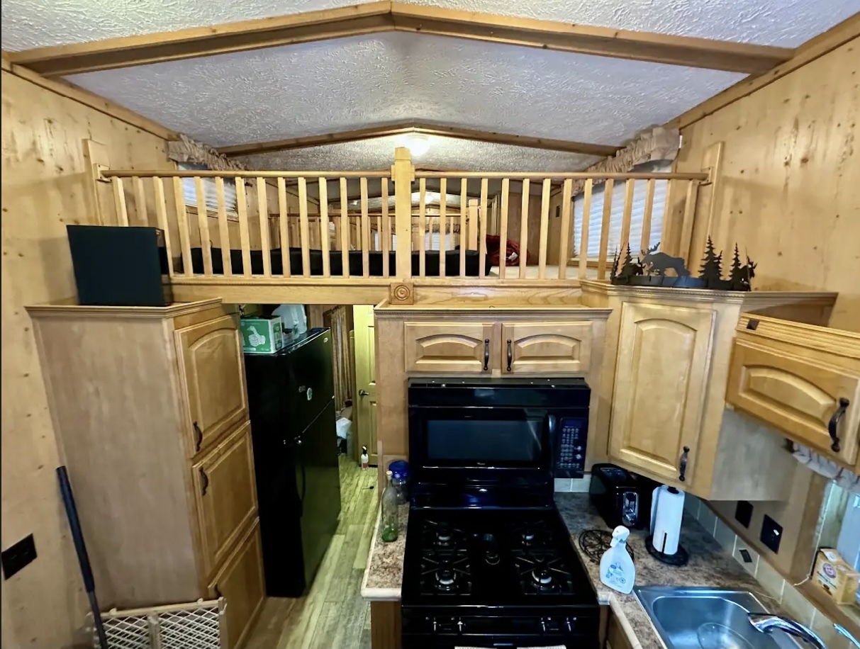 18-62-63 Woodhaven Sublette, IL 61367 - Photo 8 of 20 a kitchen with stainless steel appliances a stove a sink and a refrigerator