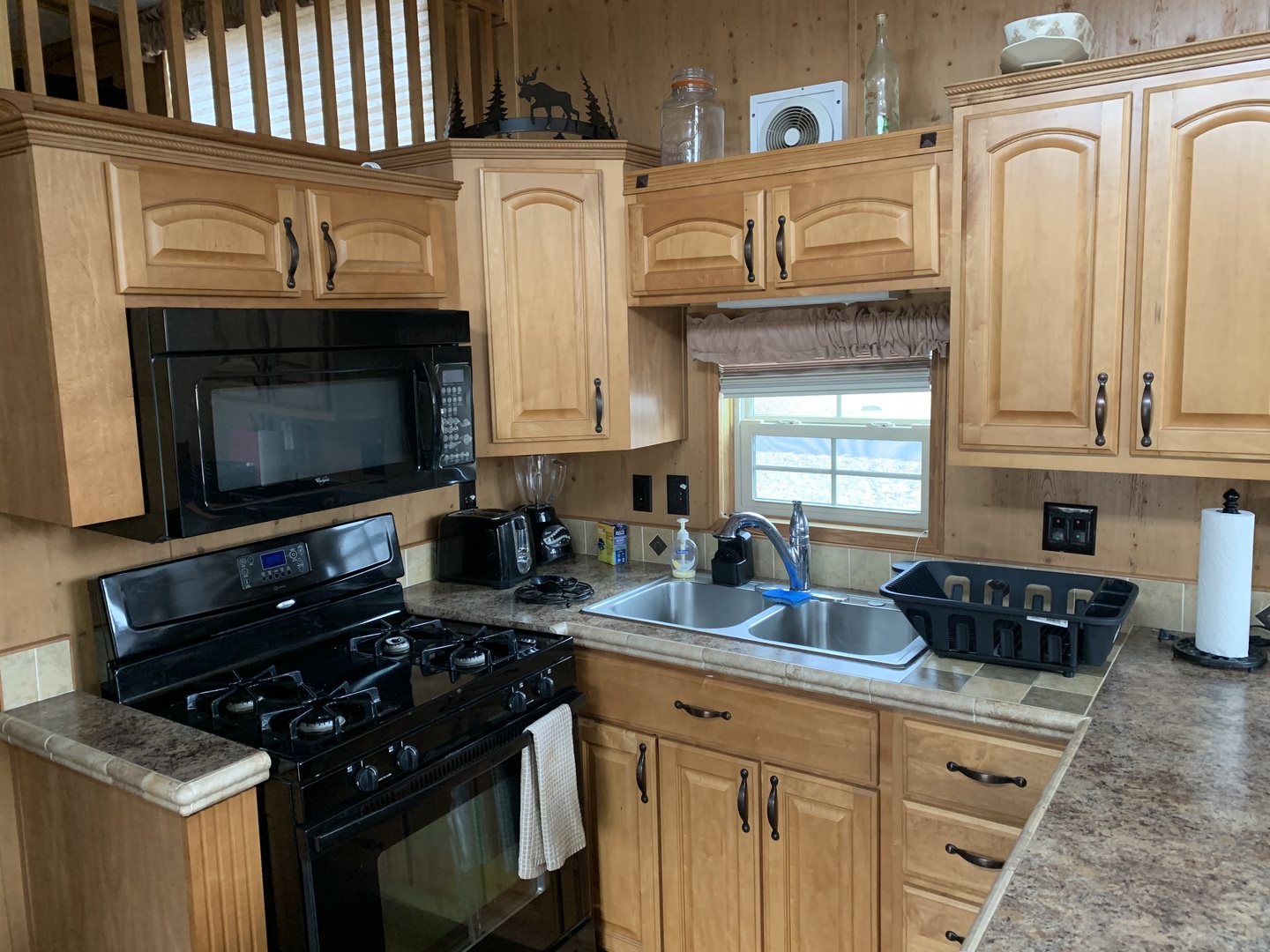 18-62-63 Woodhaven Sublette, IL 61367 - Photo 9 of 20 a kitchen with stainless steel appliances granite countertop a stove a sink and a microwave