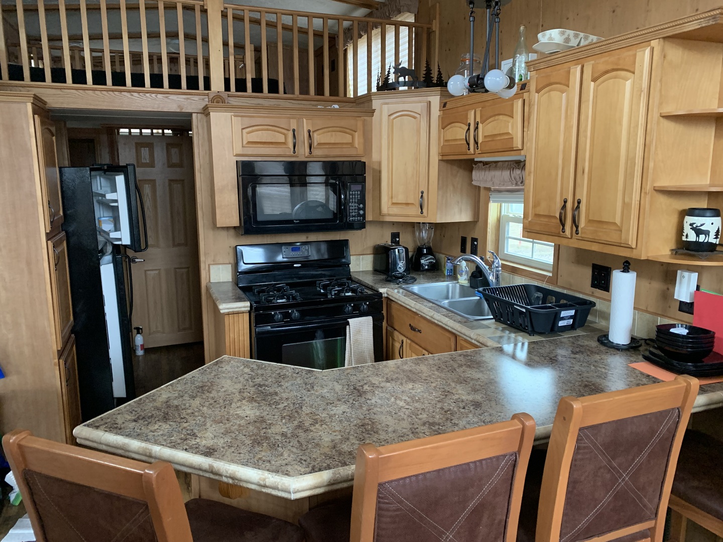 18-62-63 Woodhaven Sublette, IL 61367 - Photo 10 of 20 a kitchen with stainless steel appliances granite countertop a sink a stove and a refrigerator