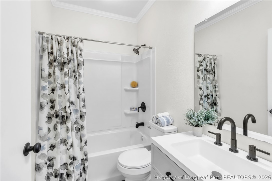 203 Trinity Street Fairmont, NC 28340 - Photo 20 of 34 a bathroom with a sink a toilet and shower
