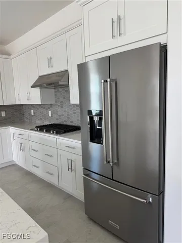 a kitchen with cabinets and stainless steel appliances