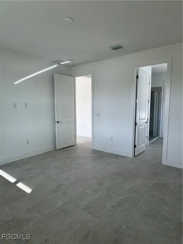 a bathroom with a double vanity sink and mirror with window