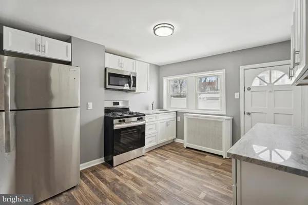 a kitchen with a refrigerator stove and sink