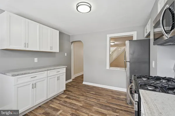 a kitchen with granite countertop a stove and a refrigerator