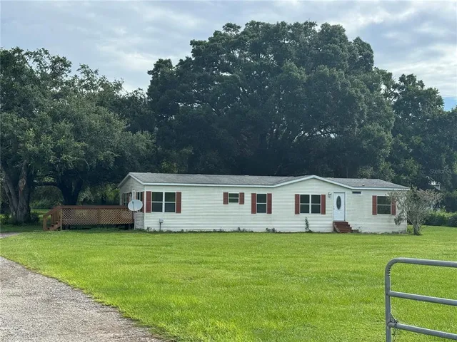 a front view of a house with a yard table and chairs