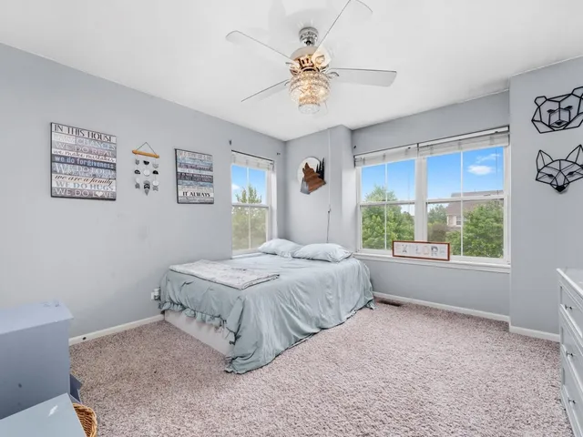 a bedroom with a large bed and a chandelier