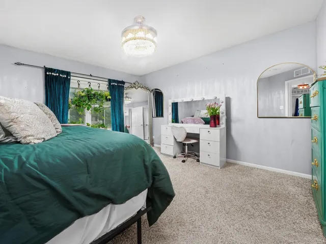 a bed room with a bed window and a chair