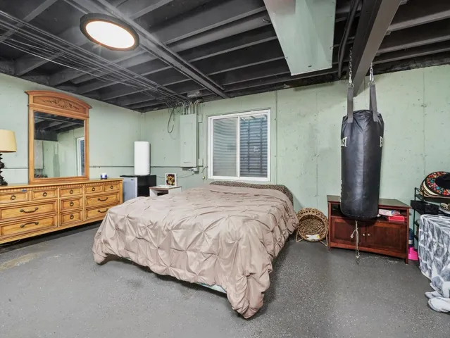 a bed sitting in a room next to a window