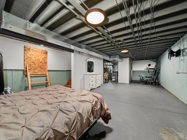 a bed sitting in a room next to a window