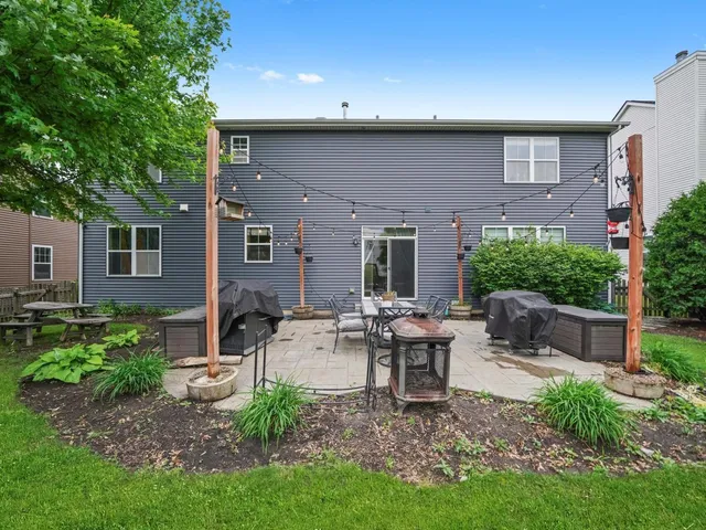 a view of a house with backyard sitting area and garden