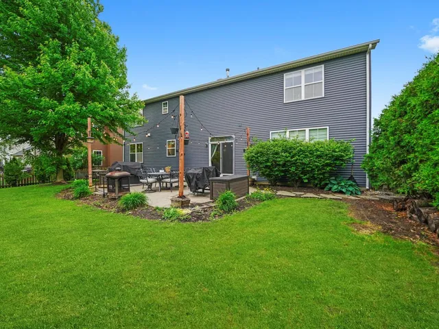 a view of a house with a backyard