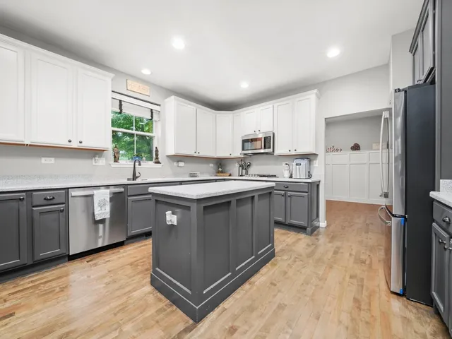 a kitchen with stainless steel appliances granite countertop a stove a sink dishwasher and a refrigerator